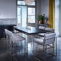 Modern dining room with a black table and gray chairs in a stylishly decorated room.